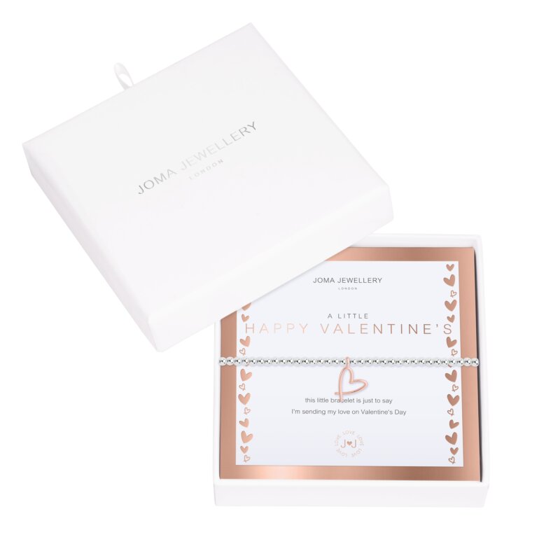 A Joma Jewellery A Little 'Happy Valentine's' Bracelet. A Stretchable Silver beaded bracelet with a rose gold heart charm, displayed on a white and rose gold card. Presented in a beautiful boxed making a perfect Valentine's Day Gift.