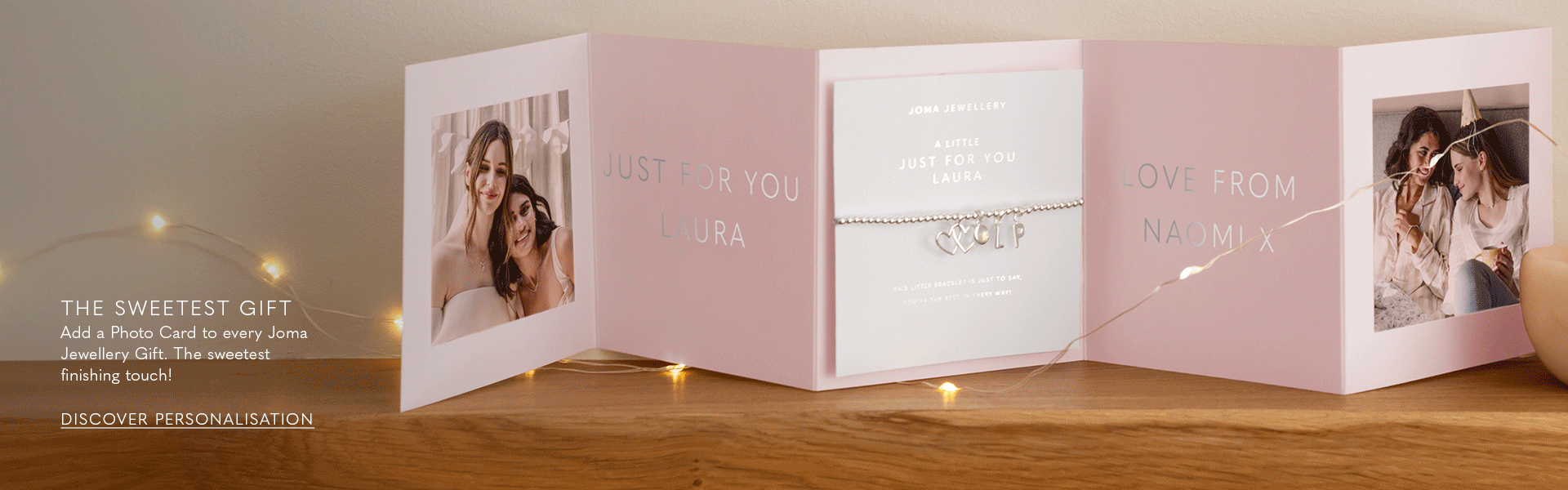 image of a personalised photo card with a silver charm bracelet with individual charms and september birthstone. The card also has a personalised message