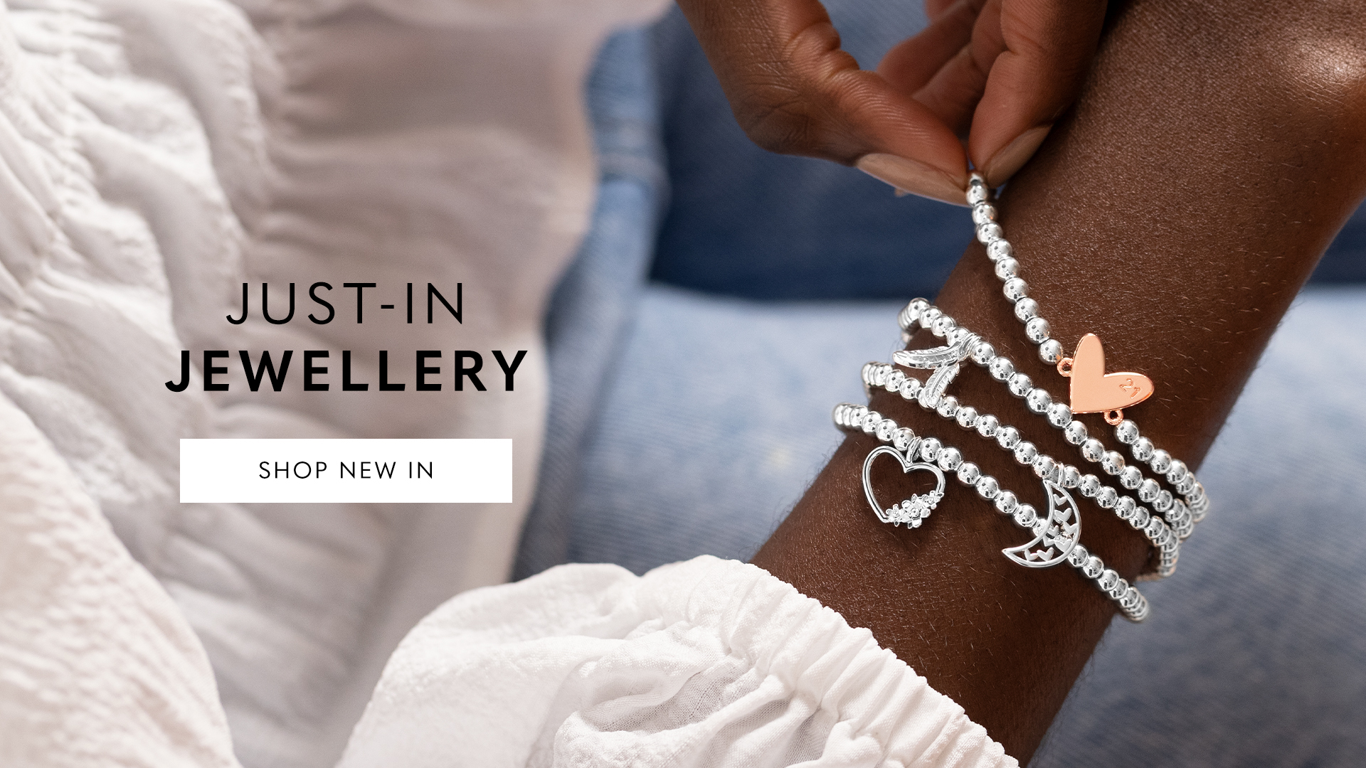 Joma Jewellery just-in jewellery showcasing our signature silver beaded A Little bracelets with a collection of charms.